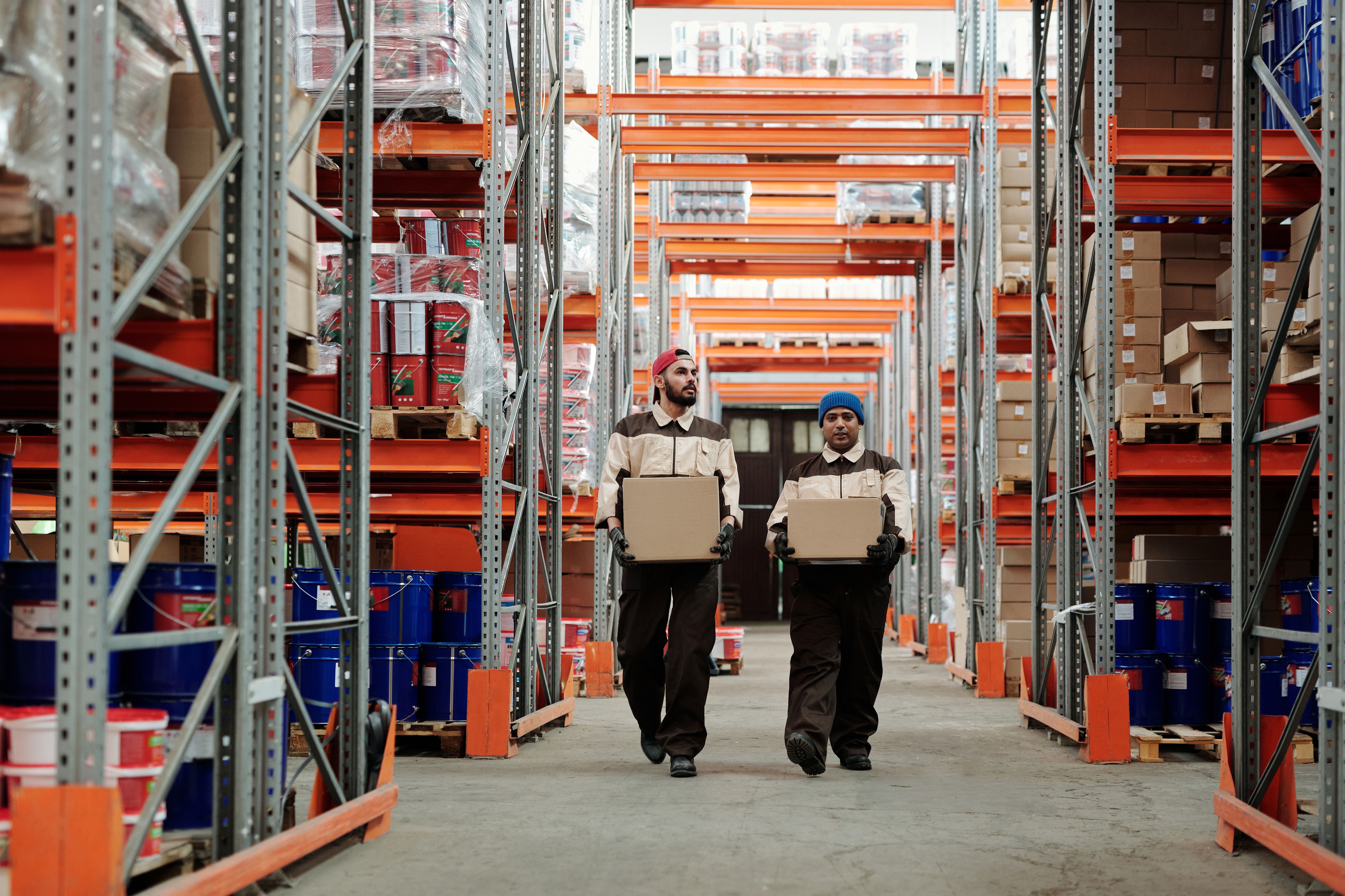 Illustrative photograph of warehouse workers handling parcels